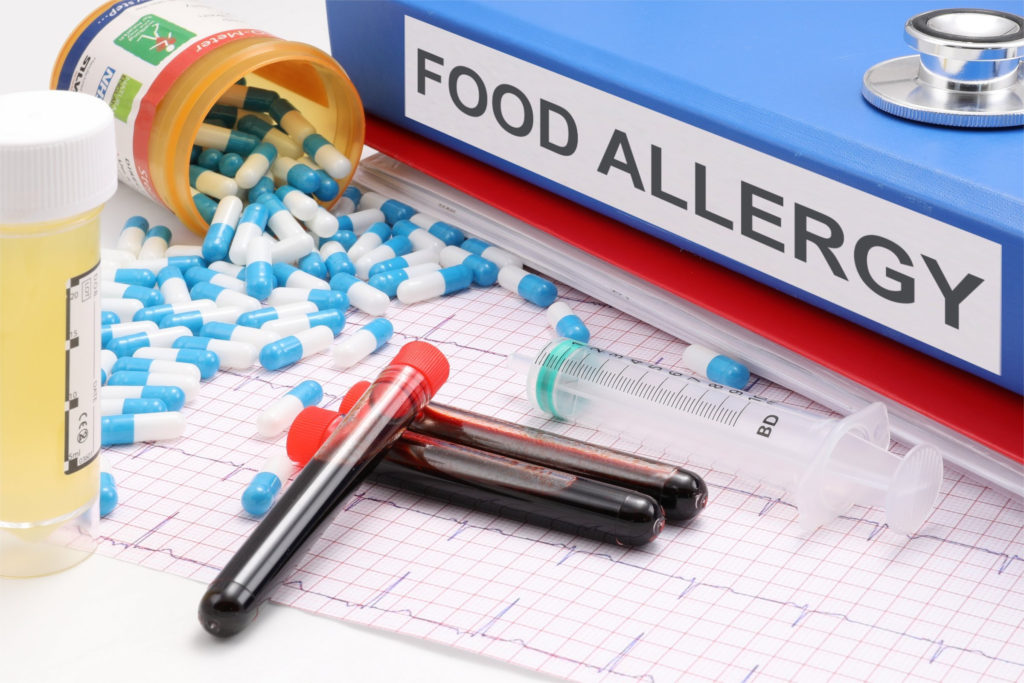 food allergy binder with pills and blood samples