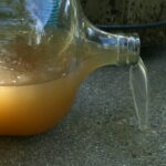 dirty water pouring from carboy