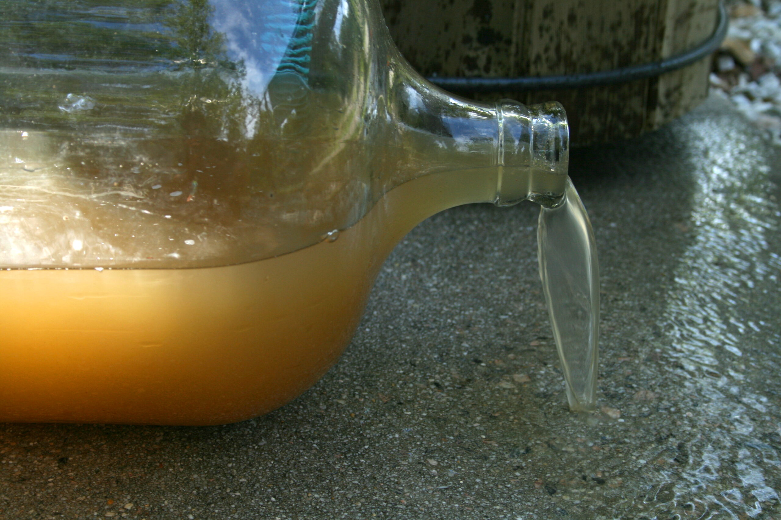 dirty water pouring from carboy